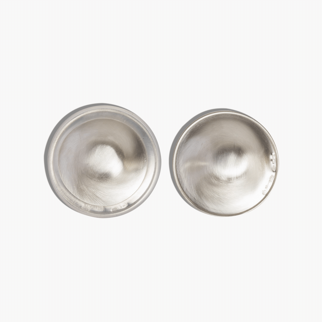Pair of Silverette 925 sterling silver nursing cups showing the smooth inner surface